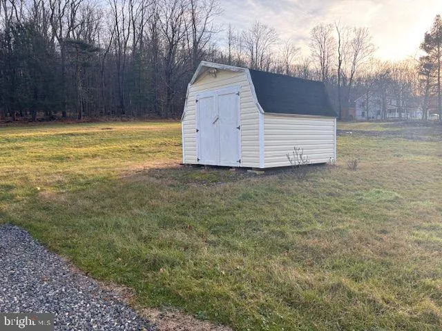 a view of a yard with wooden fence