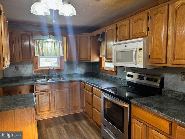 16806 Dutch Hollow Road Northwest Mount Savage, MD 21545 - Photo 6 of 17 a kitchen with stainless steel appliances granite countertop a stove a sink and a microwave