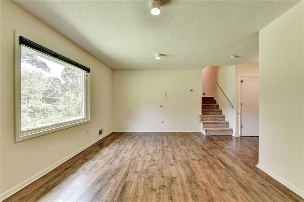 1577 Harbour Oaks Road Tucker, GA 30084 - Photo 10 of 58 a view of an empty room with wooden floor and a window