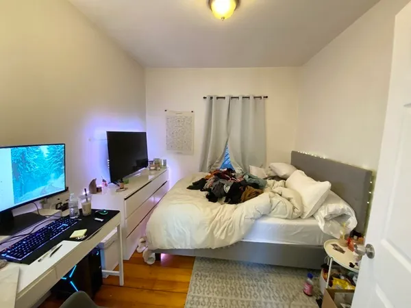 a bedroom with a bed and a flat screen tv