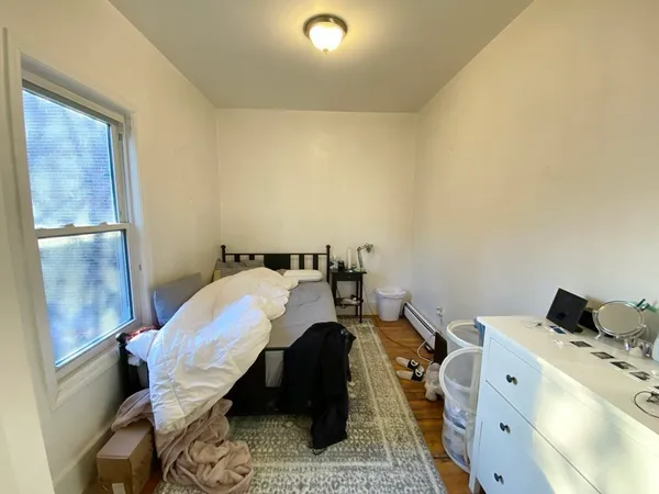a bed room with a bed and a chair