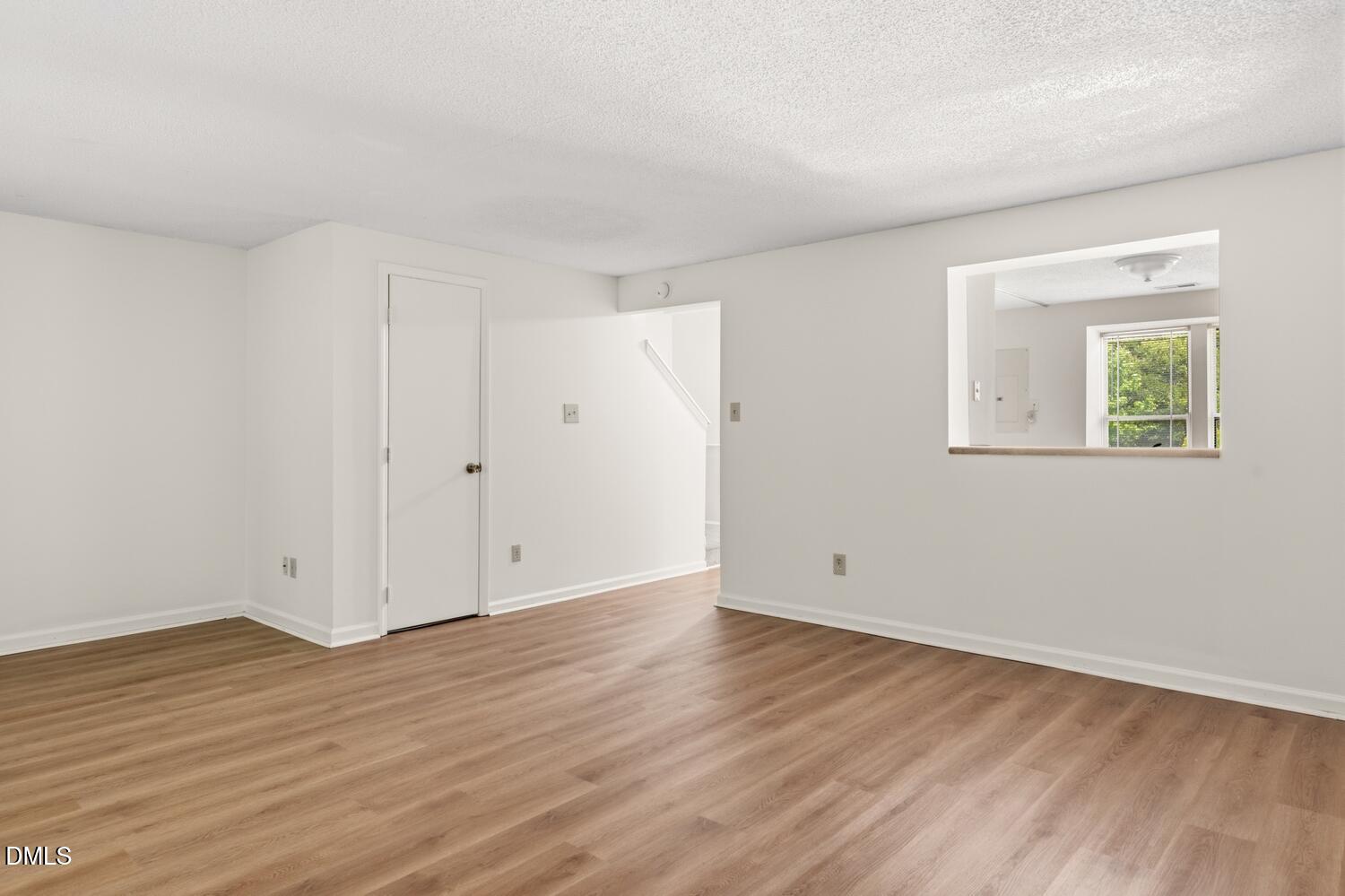 1135 Villa Green Court Raleigh, NC 27612 - Photo 8 of 17 a view of an empty room with wooden floor