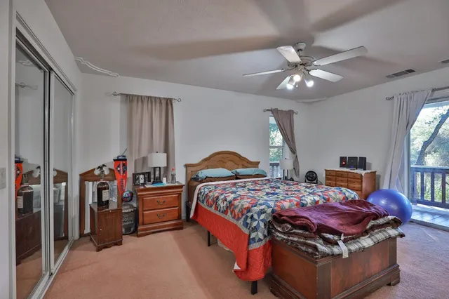 a bedroom with a bed and ceiling fan