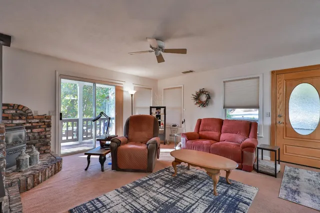 a living room with furniture a rug and a chandelier