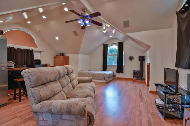 a living room with furniture a wooden floor and a flat screen tv