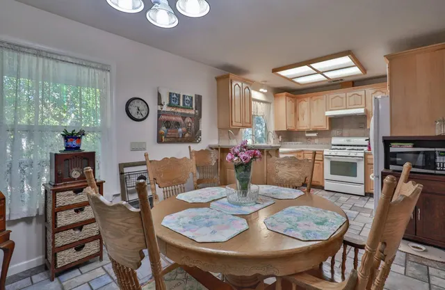 a view of a dining room with furniture and a large window