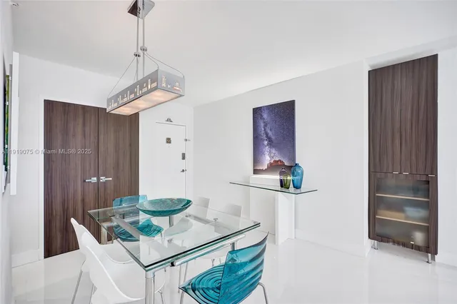 a kitchen with kitchen island a counter top space a sink stainless steel appliances and cabinets