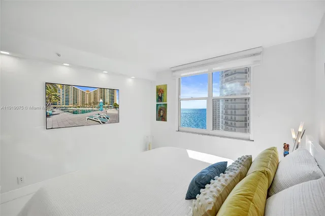 a room with furniture pool table and wooden floor
