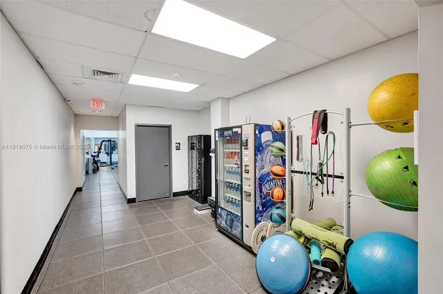 a living room with furniture a chandelier and a potted plant