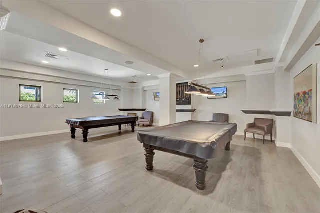 a view of swimming pool with outdoor seating and plants