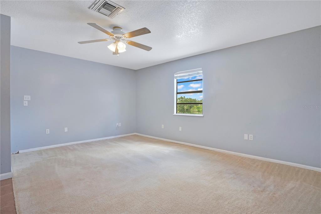 5785 Gilliam Road Orlando, FL 32818 - Photo 73 of 100 an empty room with a window and a ceiling fan