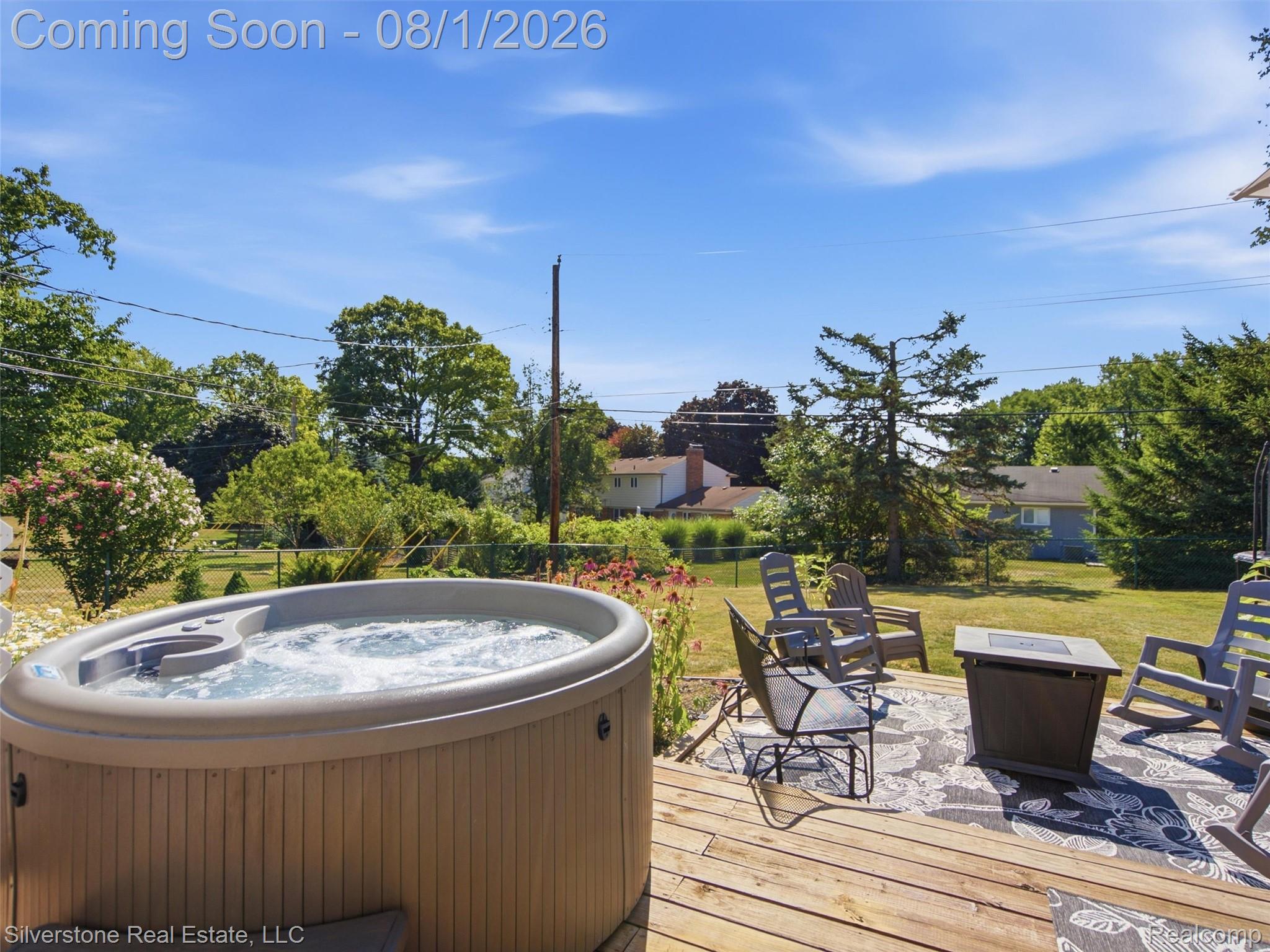 2135 Wayward Drive Rochester, MI 48309 - Photo 52 of 55 Spacious wood-decked patio featuring a built-in hot tub, ample seating area, and a fire pit