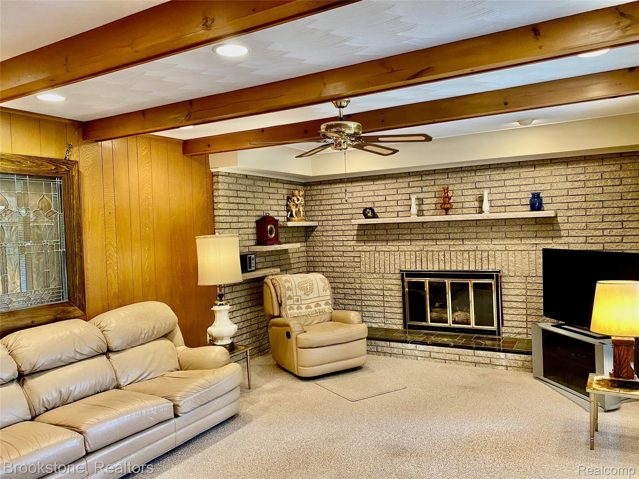 838 Wilwood Road Rochester, MI 48309 - Photo 28 of 53 IN THE LARGE FAMILY ROOM (13X21) CHECKOUT THE BRICK WALL (WITH BUILT-IN SHELVES) THAT SURROUNDS THE NATURAL/GAS FIREPLACE