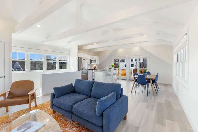 a living room with furniture fireplace and a window