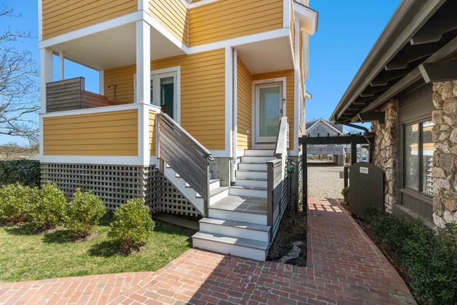 a view of a house with stairs and a yard