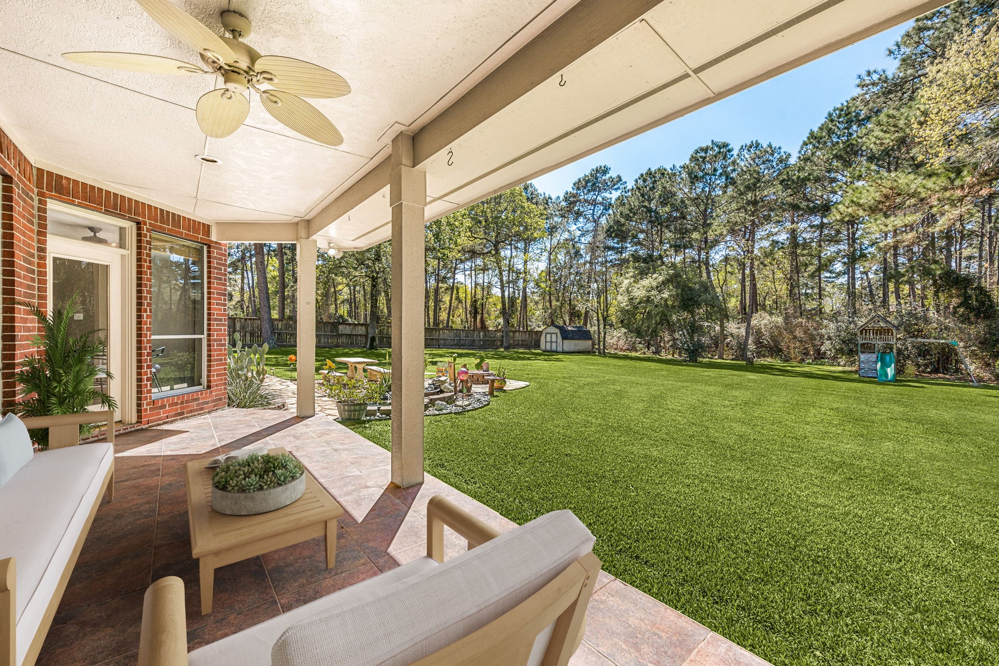 14419 Timbergreen Drive Magnolia, TX 77355 - Photo 28 of 43 Enjoy the spacious covered patio overlooking a large backyard with mature trees, perfect for relaxing, entertaining, or outdoor activities. *virtually staged*