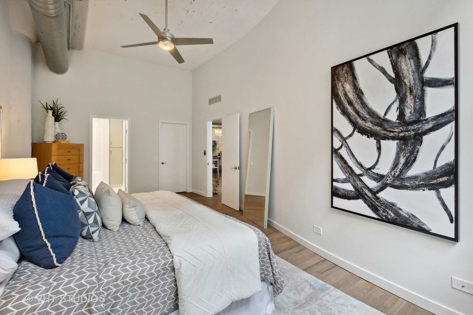 17 North Loomis Street, Unit 1J Chicago, IL 60607 - Photo 12 of 30 a bedroom with a bed a couch and painting on the wall
