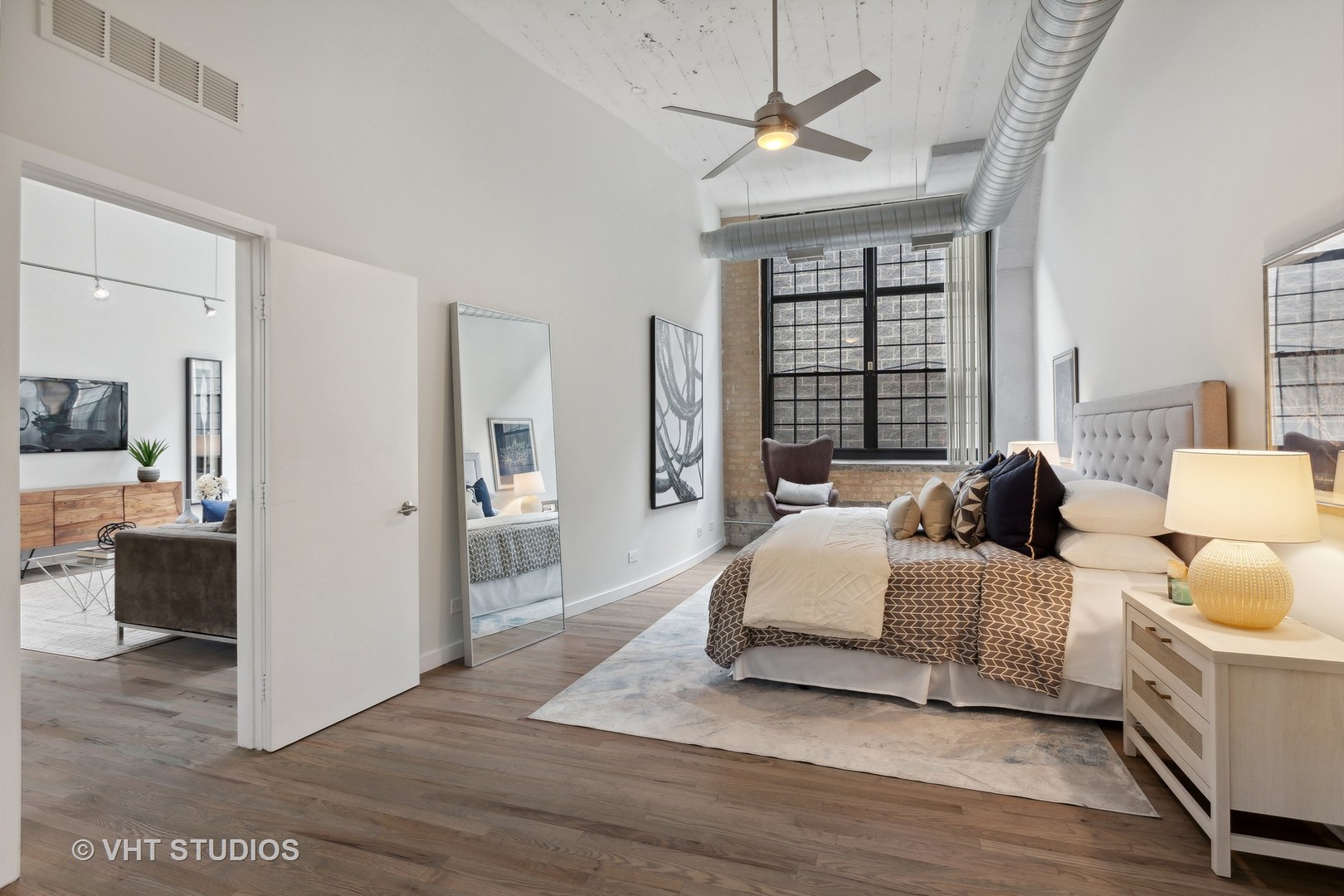 17 North Loomis Street, Unit 1J Chicago, IL 60607 - Photo 13 of 30 a spacious bedroom with a bed and a walk in closet