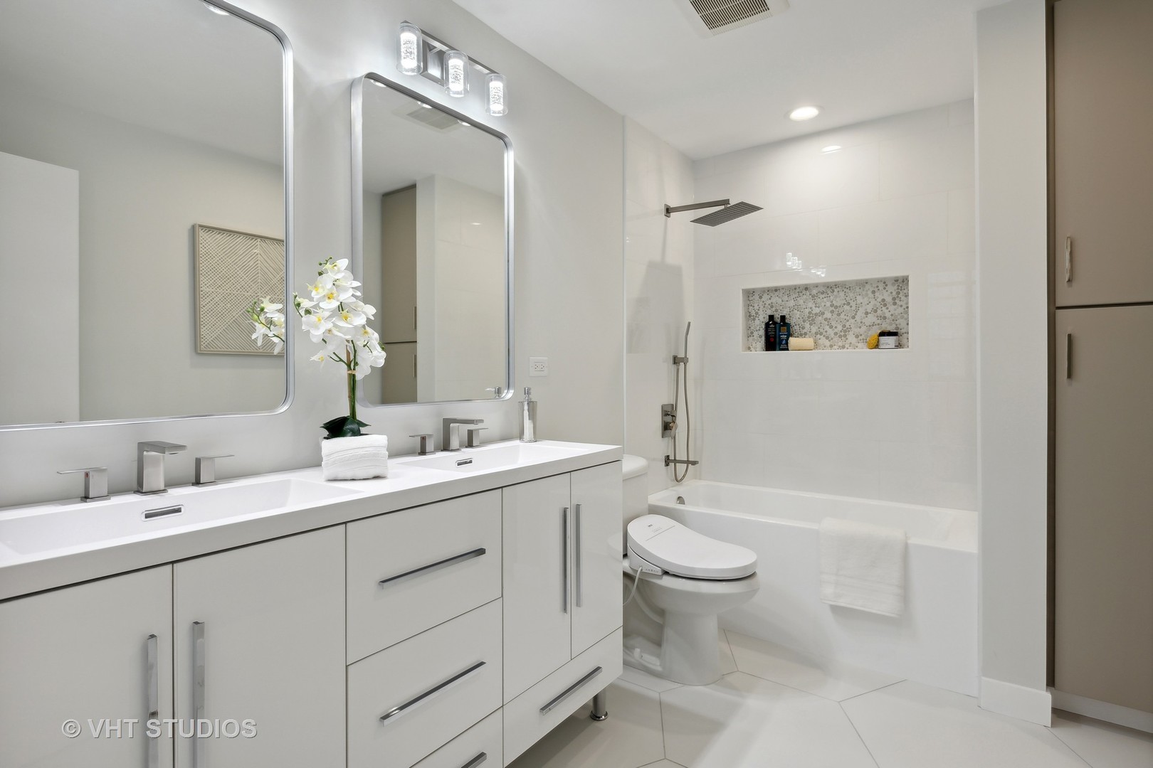 17 North Loomis Street, Unit 1J Chicago, IL 60607 - Photo 14 of 30 a bathroom with a double vanity sink toilet mirror and shower