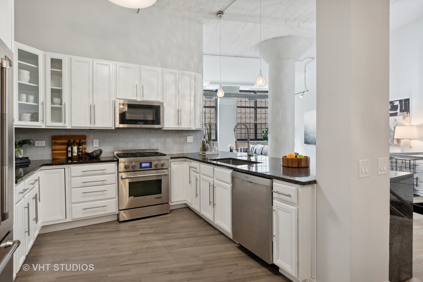 17 North Loomis Street, Unit 1J Chicago, IL 60607 - Photo 8 of 30 a kitchen with stainless steel appliances a stove a sink a refrigerator a microwave a sink and cabinets
