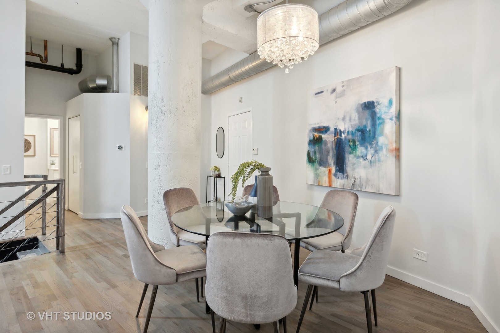 17 North Loomis Street, Unit 1J Chicago, IL 60607 - Photo 9 of 30 a dining room with furniture a chandelier and wooden floor