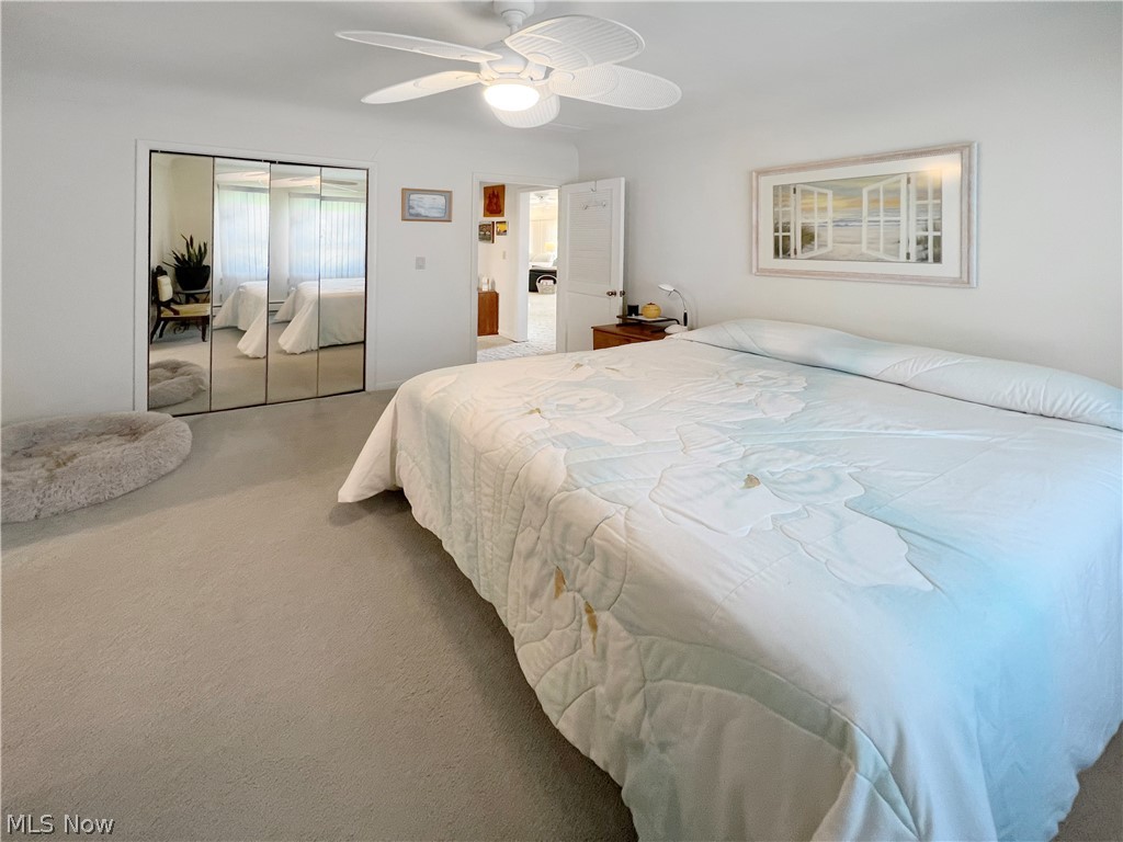4663 East Harbor Road Port Clinton, OH 43452 - Photo 18 of 31 Bedroom with a closet, ceiling fan, and carpet