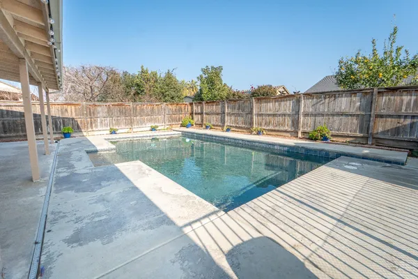 a view of a swimming pool with a lounge chair