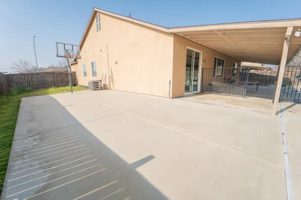 a view of a hallway with wooden floor and a yard