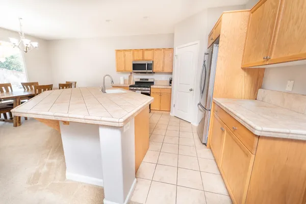 a kitchen with a sink a stove a refrigerator and cabinets