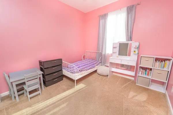 a bedroom with furniture and a book shelf