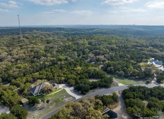 an aerial view of a house with a yard