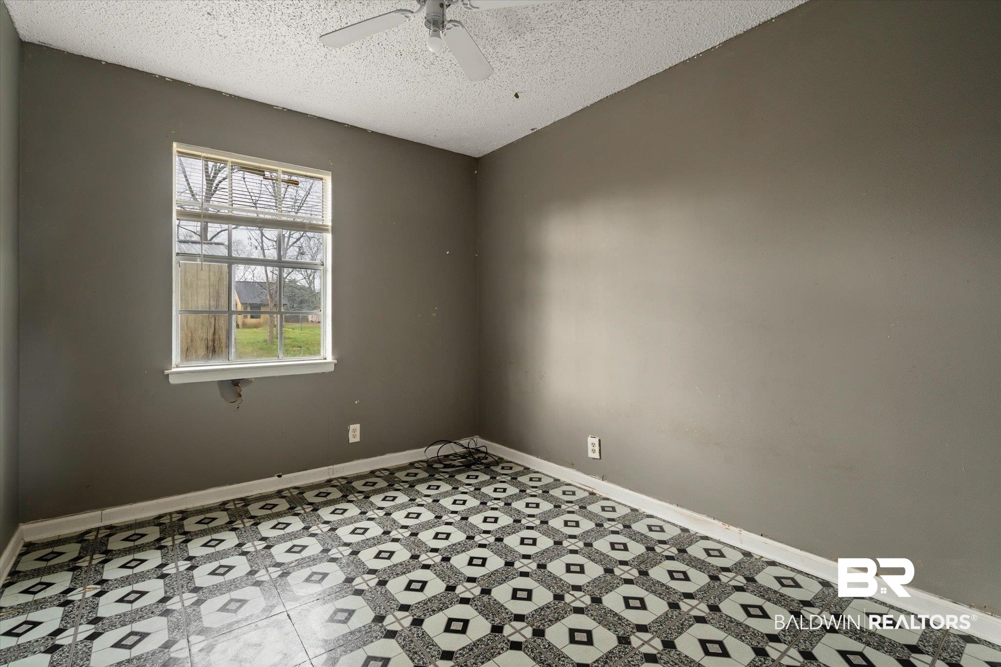 313 West 4th Avenue Foley, AL 36535 - Photo 15 of 20 Spare room featuring a textured ceiling and ceiling fan