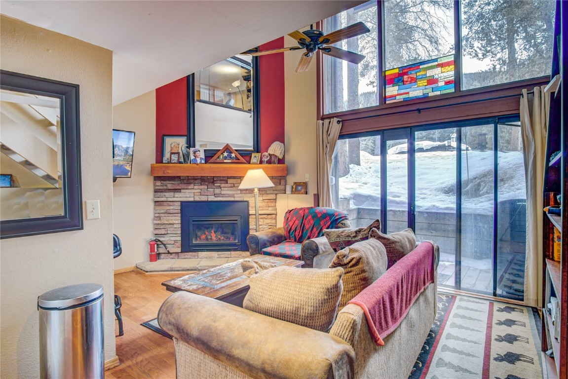 78 Guller Road, Unit 104 Copper Mountain, CO 80443 - Photo 2 of 15 a living room with furniture a fireplace and a floor to ceiling window