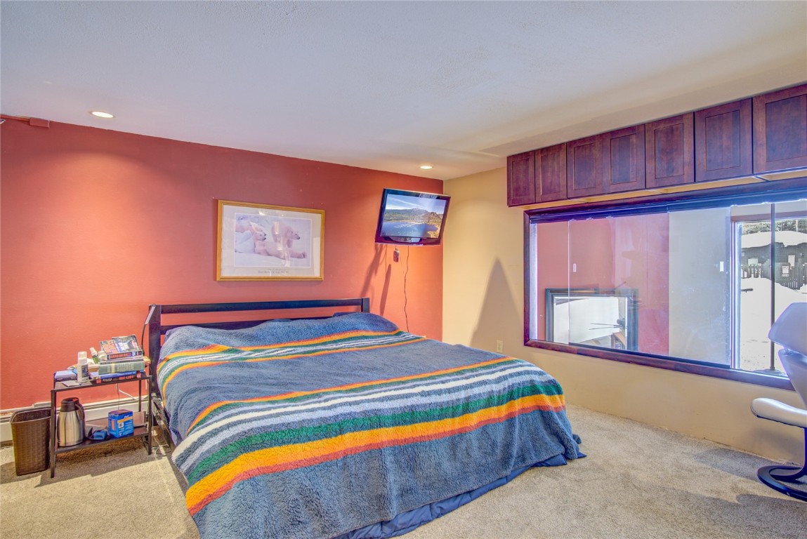 78 Guller Road, Unit 104 Copper Mountain, CO 80443 - Photo 8 of 15 a bedroom with a bed and wooden floor