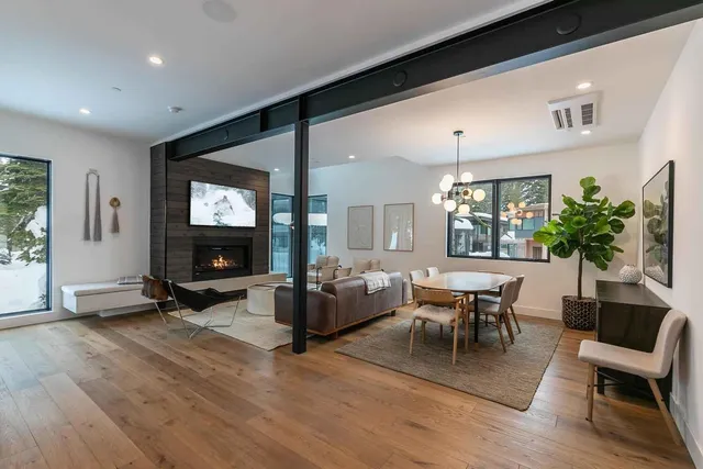 a living room with furniture a large window and a flat screen tv
