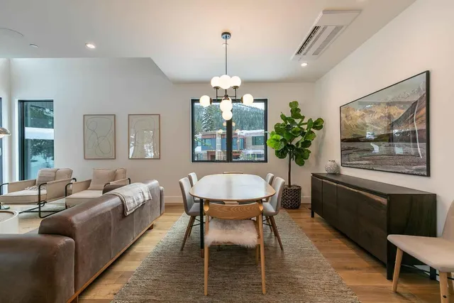 a living room with furniture and a chandelier