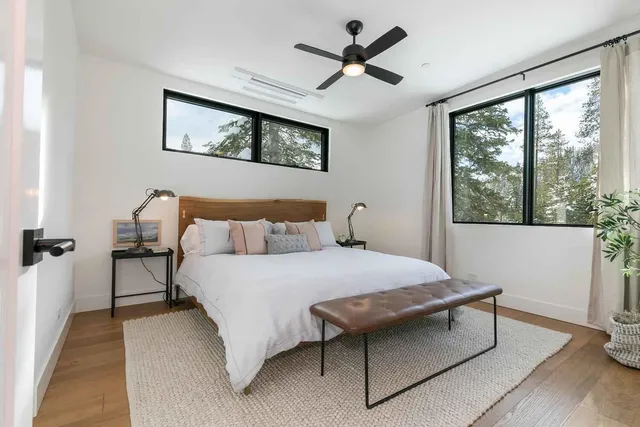 a bedroom with a bed a window and a chandelier