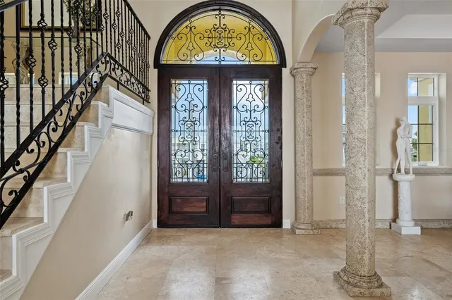 a dining room with a wooden table and chairs
