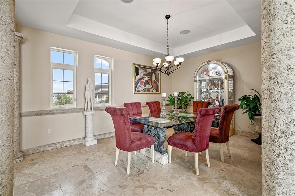 3236 Gulf Winds Circle Hernando Beach, FL 34607 - Photo 14 of 96 a view of a dining room with furniture and a chandelier