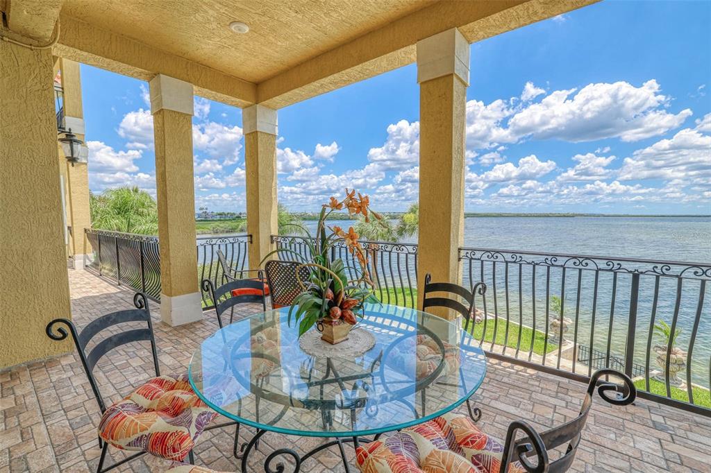 3236 Gulf Winds Circle Hernando Beach, FL 34607 - Photo 20 of 96 a dining room with furniture a chandelier and wooden floor