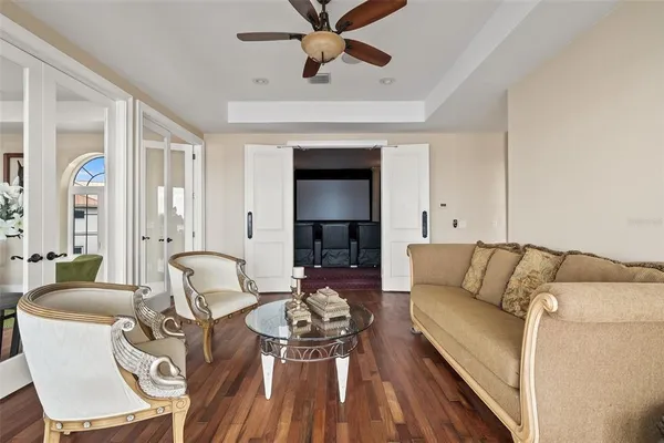 a view of a hallway with wooden floor and windows