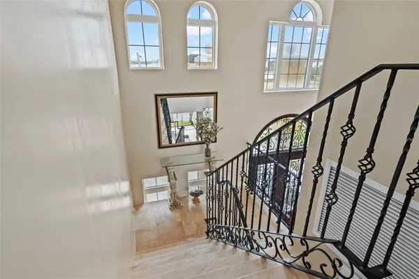 a bedroom with a large bed wooden floor and window