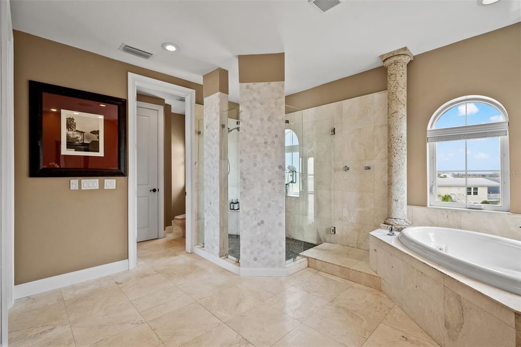 3236 Gulf Winds Circle Hernando Beach, FL 34607 - Photo 57 of 96 a spacious bathroom with a shower a sink and a large mirror