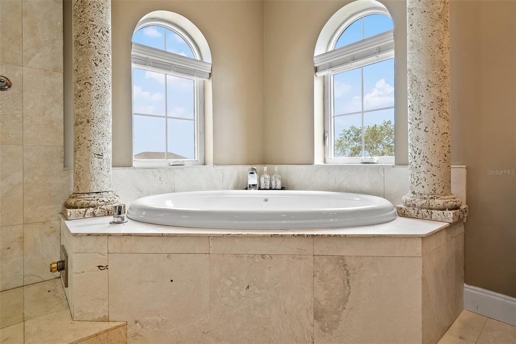 3236 Gulf Winds Circle Hernando Beach, FL 34607 - Photo 58 of 96 a bathroom with a granite countertop sink a mirror and a bathtub