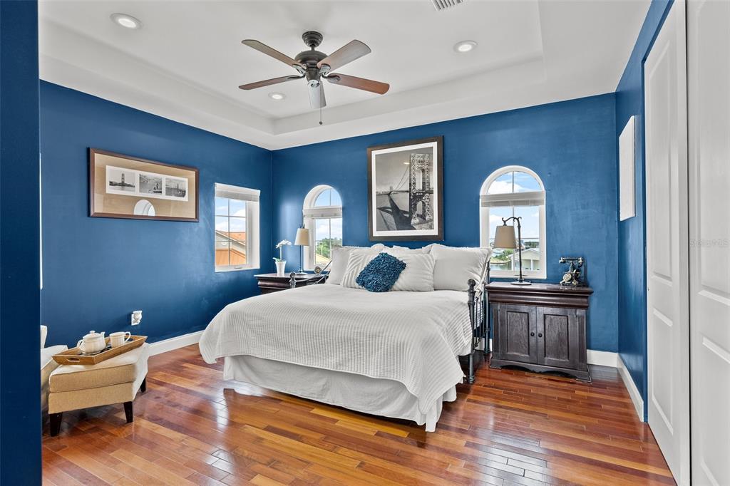 3236 Gulf Winds Circle Hernando Beach, FL 34607 - Photo 80 of 96 a bedroom with a large bed wooden floor and window