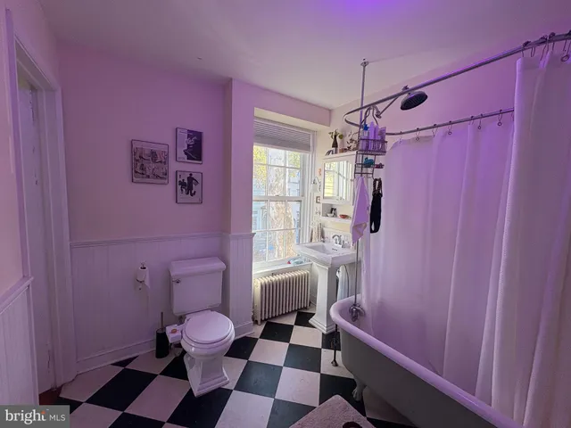 a bathroom with a granite countertop toilet sink and shower