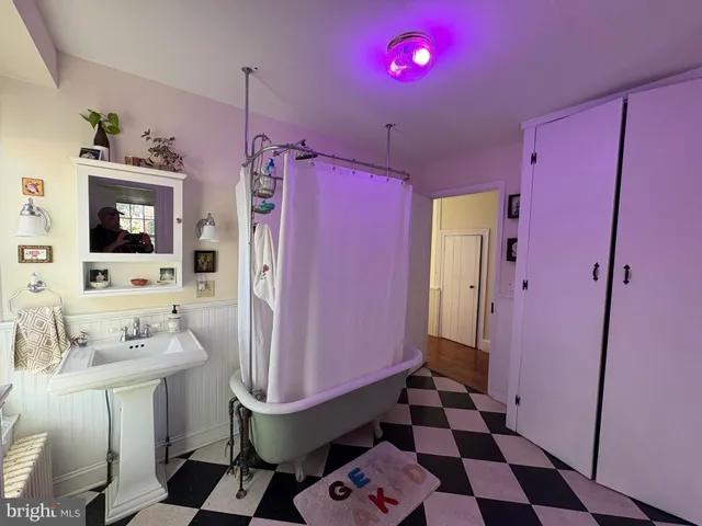 a bathroom with a sink a mirror a toilet and shower
