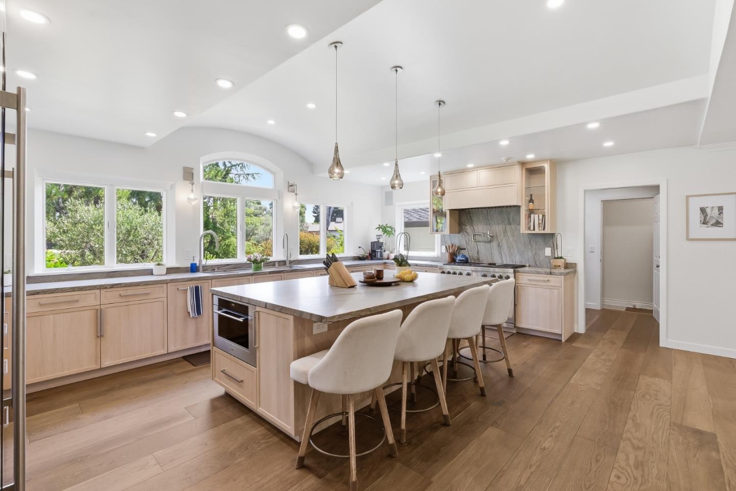 285 Ridgeway Road Woodside, CA 94062 - Photo 9 of 28 a kitchen with stainless steel appliances granite countertop wooden floor and white cabinets
