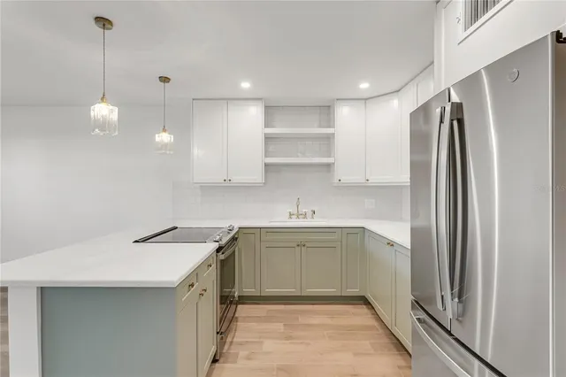 a kitchen with a sink stainless steel appliances and cabinets
