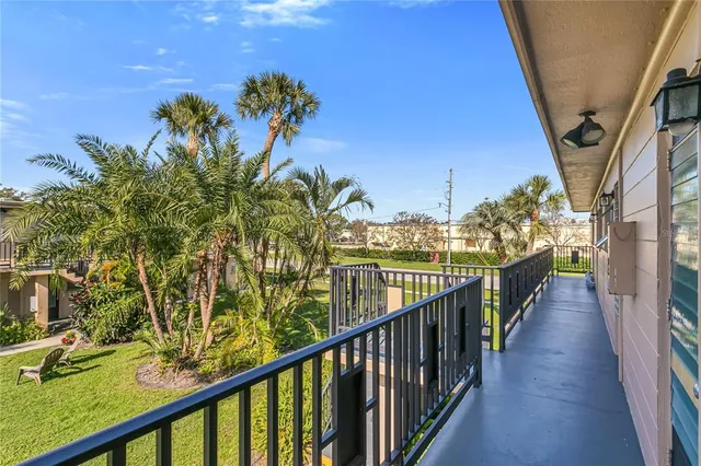 a view of a balcony with wooden stairs